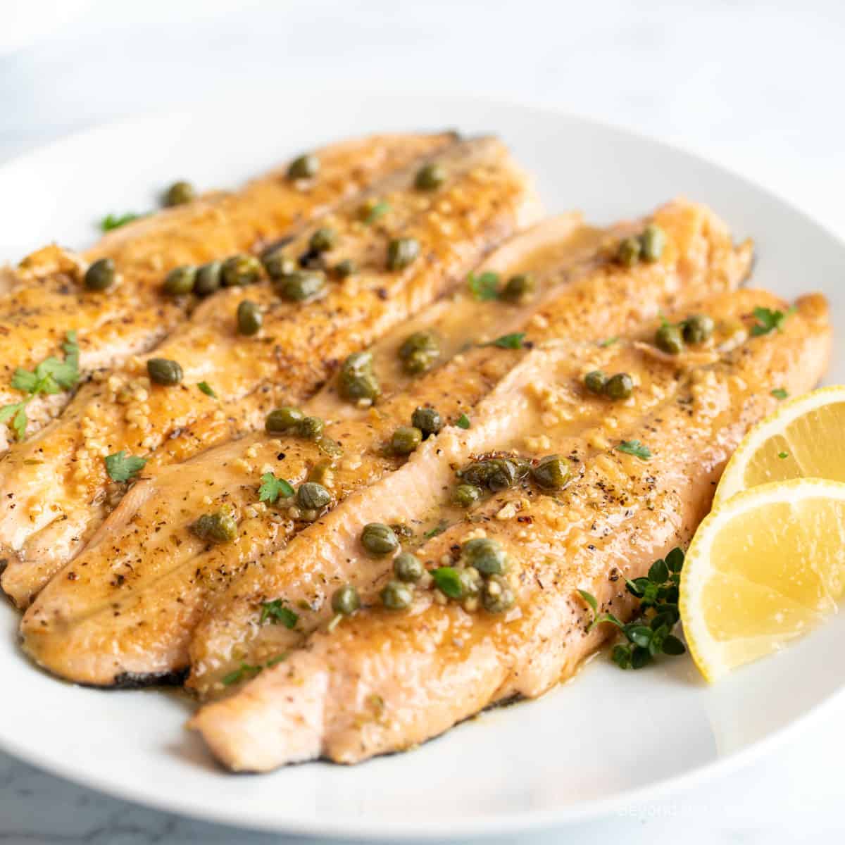Trout fillets topped with capers.