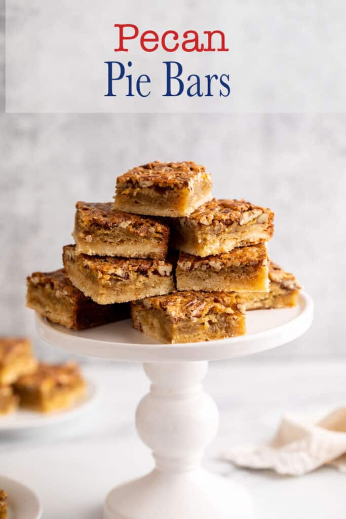 Pecan squares stacked on a white pedastal stand.