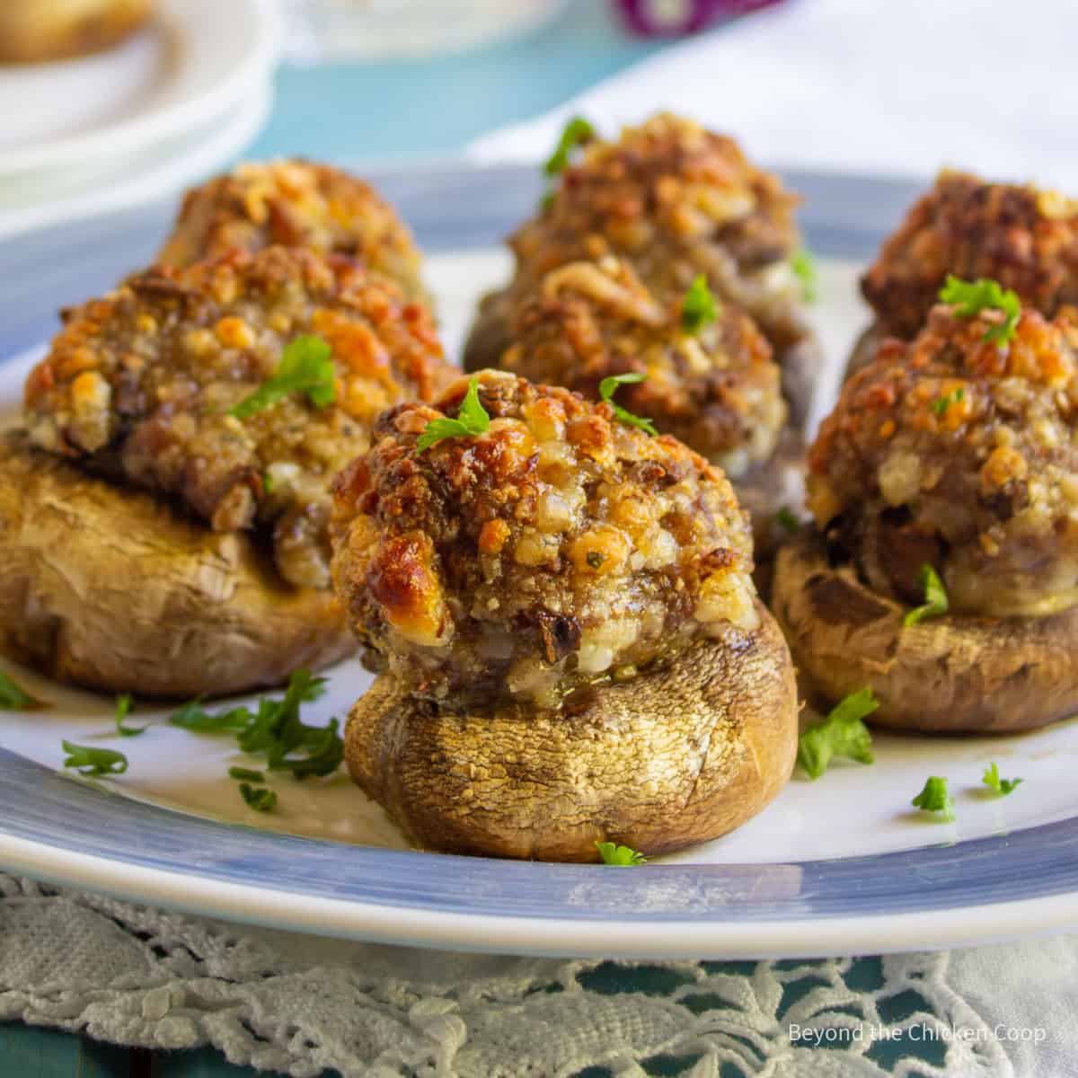 Stuffed mushrooms on a blue and white plate. 