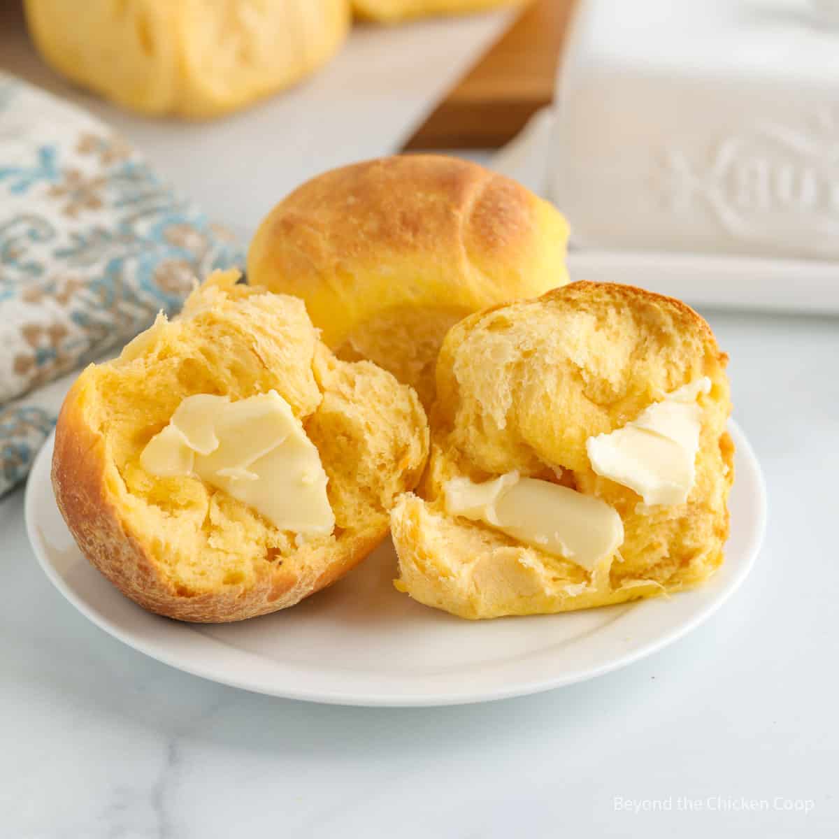 Dinner roll split in half and slathered with butter.