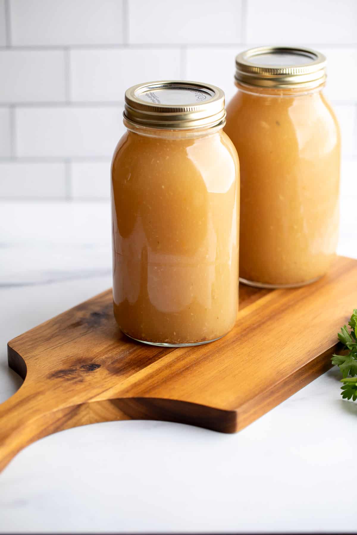 Canning jars filled with broth.