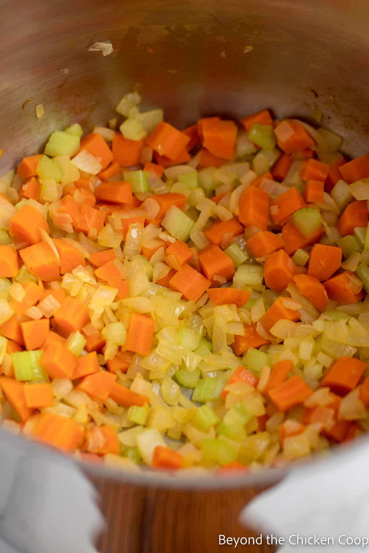 Sauteed veggies in a soup pot. 