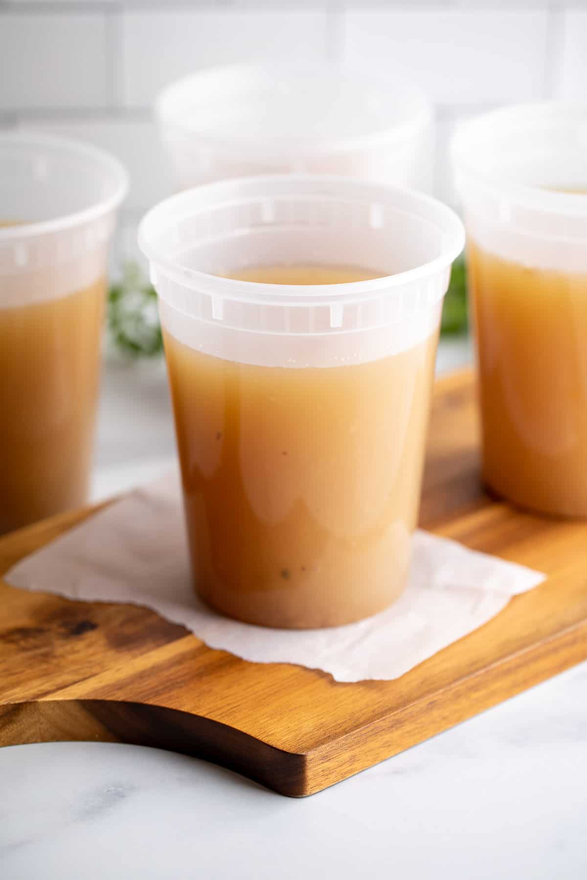 Plastic containers filled with turkey bone broth. 