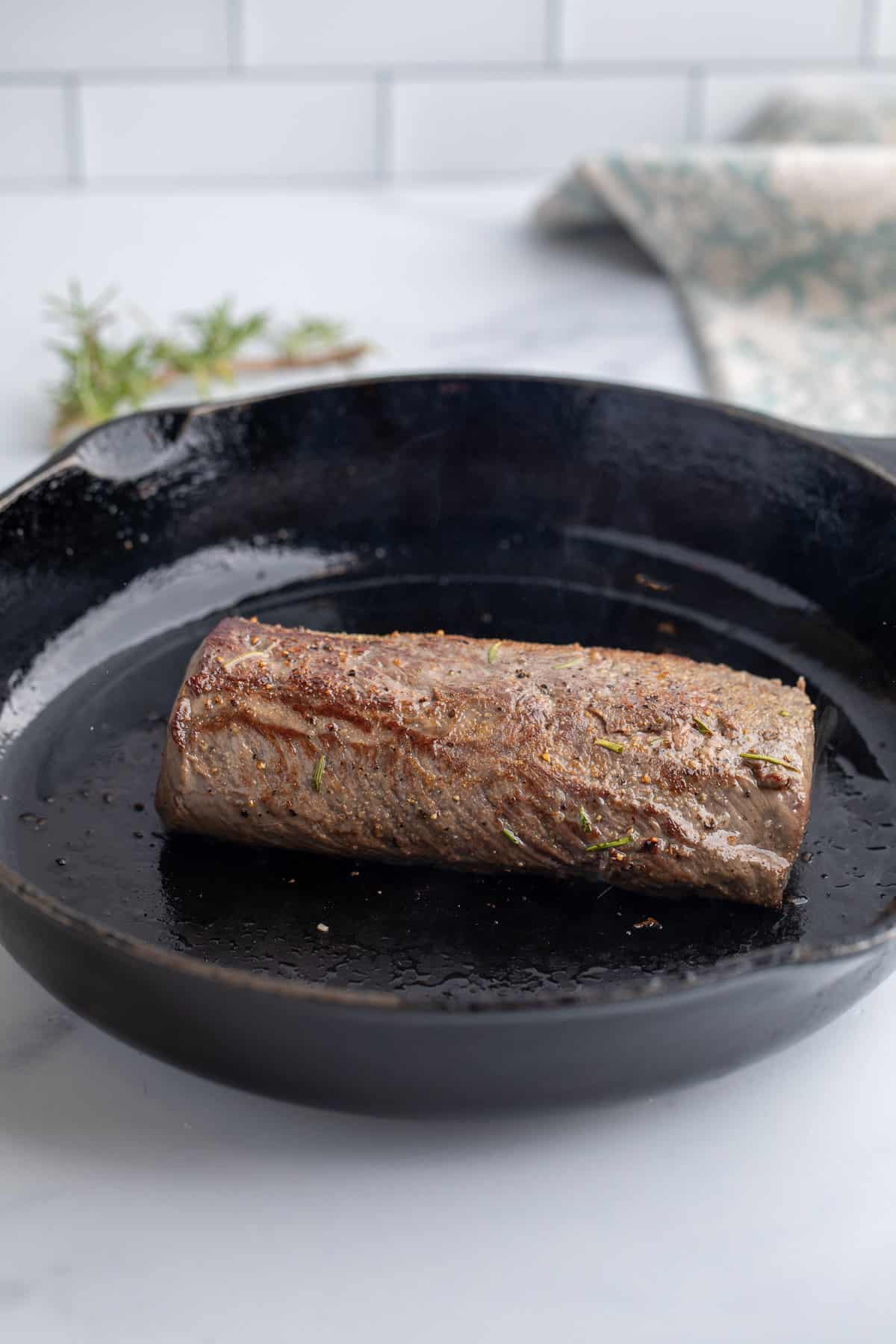 Seared meat in a cast iron skillet.