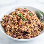 A bowl filled with wild rice, cranberries and pecans.