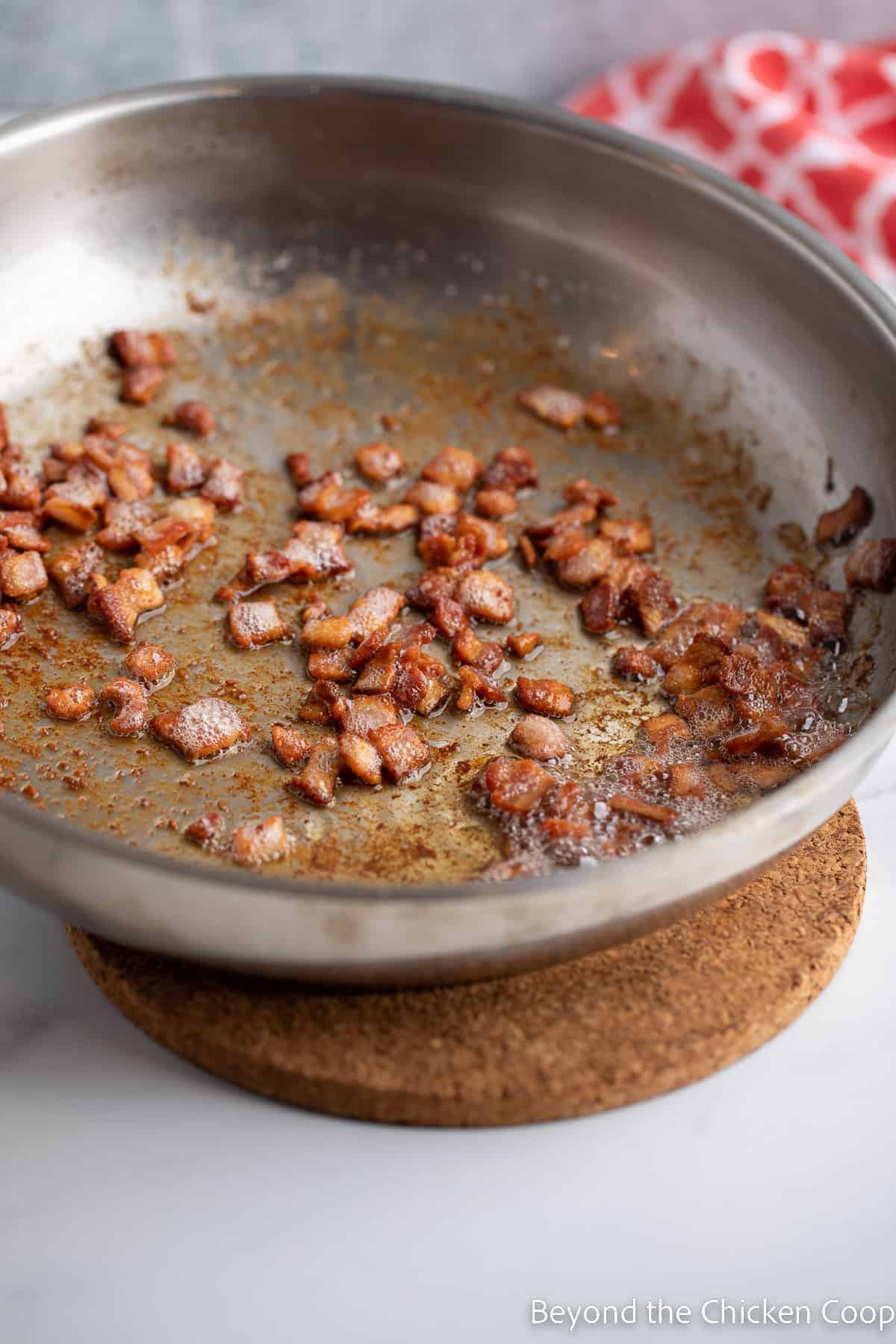 Crispy bacon in a saute pan. 