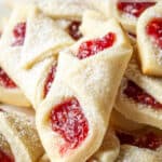 Raspberry filled cookies topped with powdered sugar.