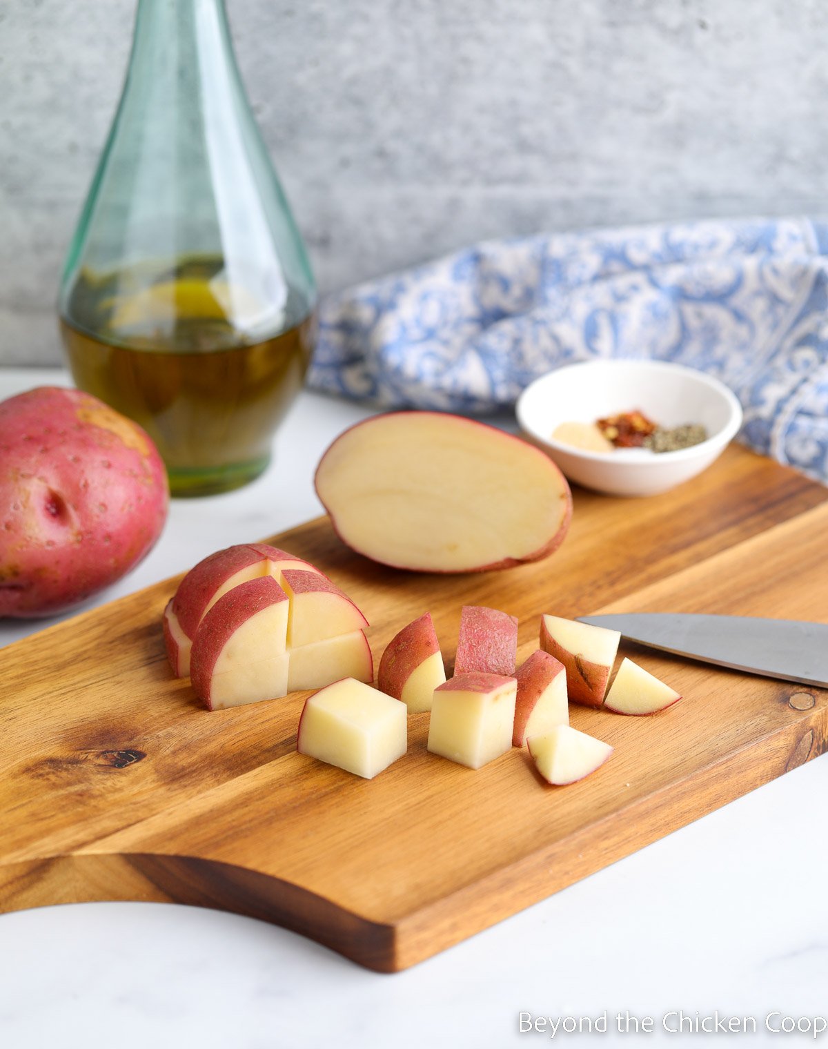 Cut potatoes on a cutting board. 