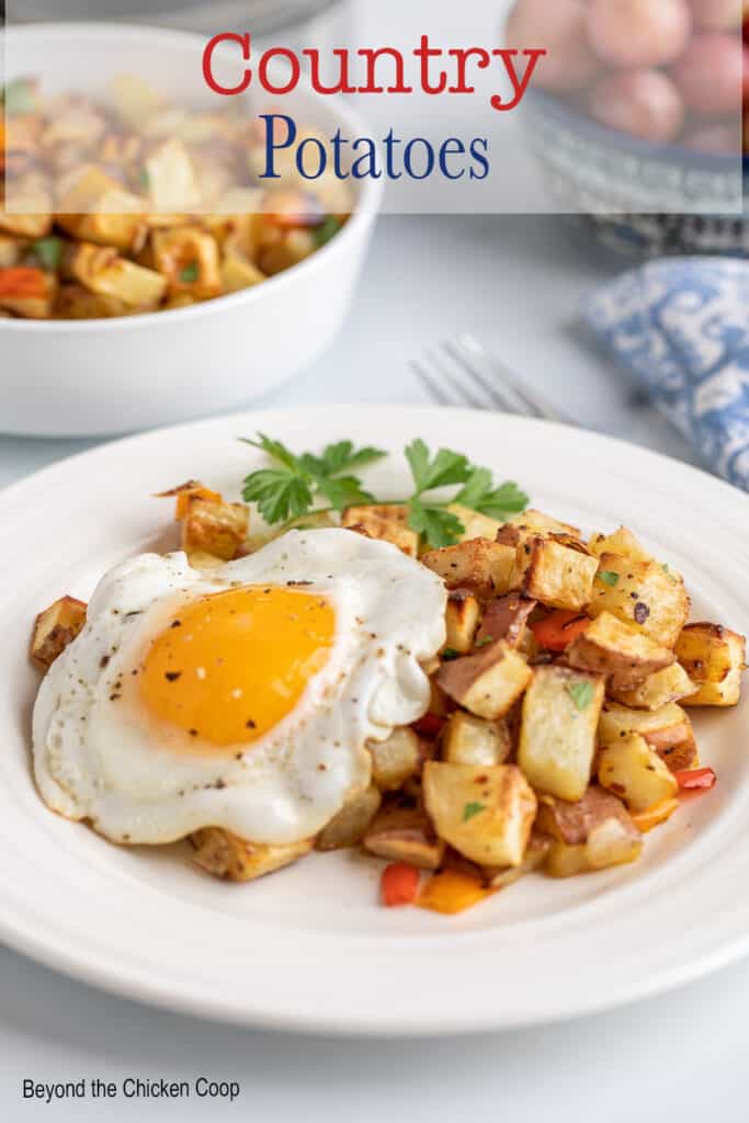 A fried egg over breakfast potatoes.