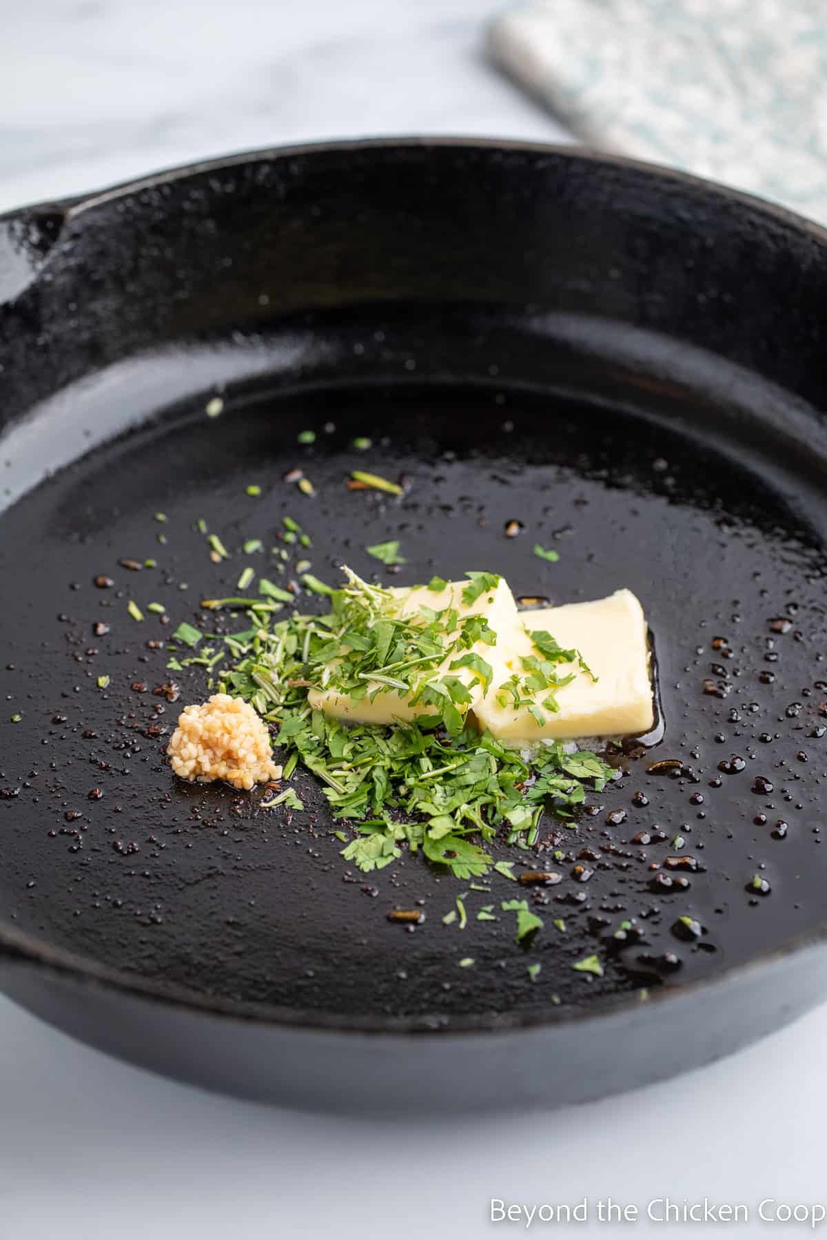 Butter, garlic and parsley in a pan.