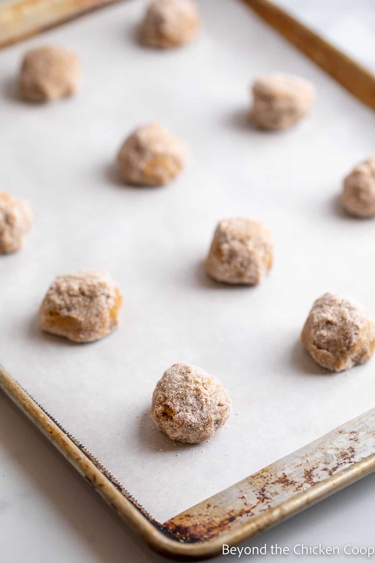 Balls of cookie dough on a cookie sheet.