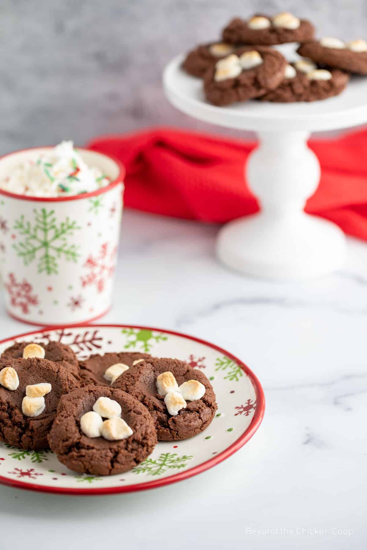 A plate of cookies topped with marshmallows.