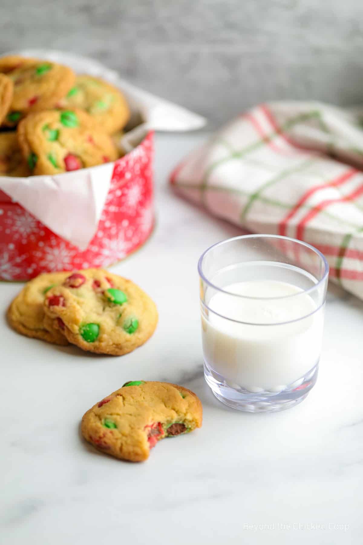 Cookies next to a glass of milk. 