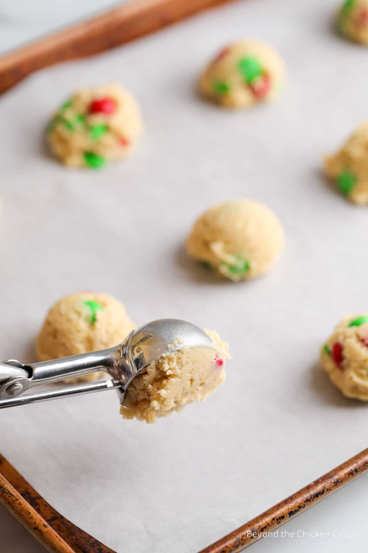 Scooping dough onto a baking sheet. 