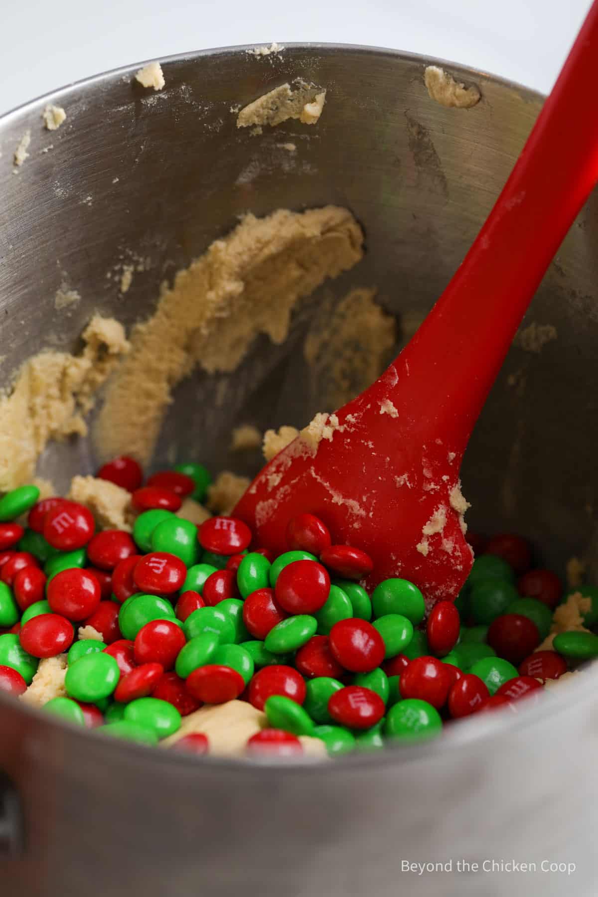Folding M&Ms into cookie batter. 