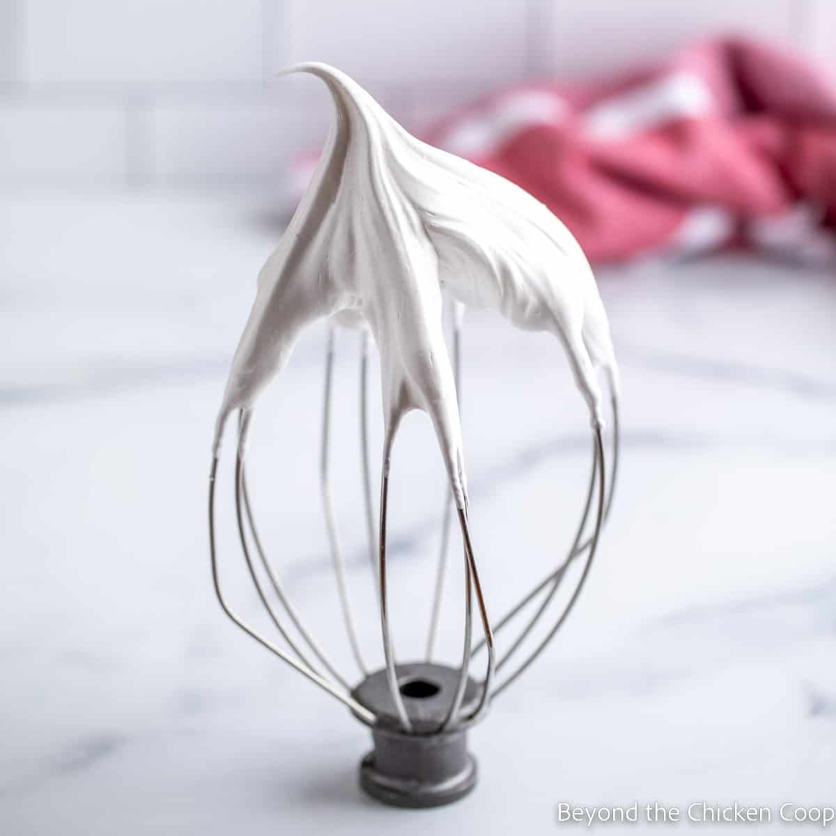 Meringue on a whisk.
