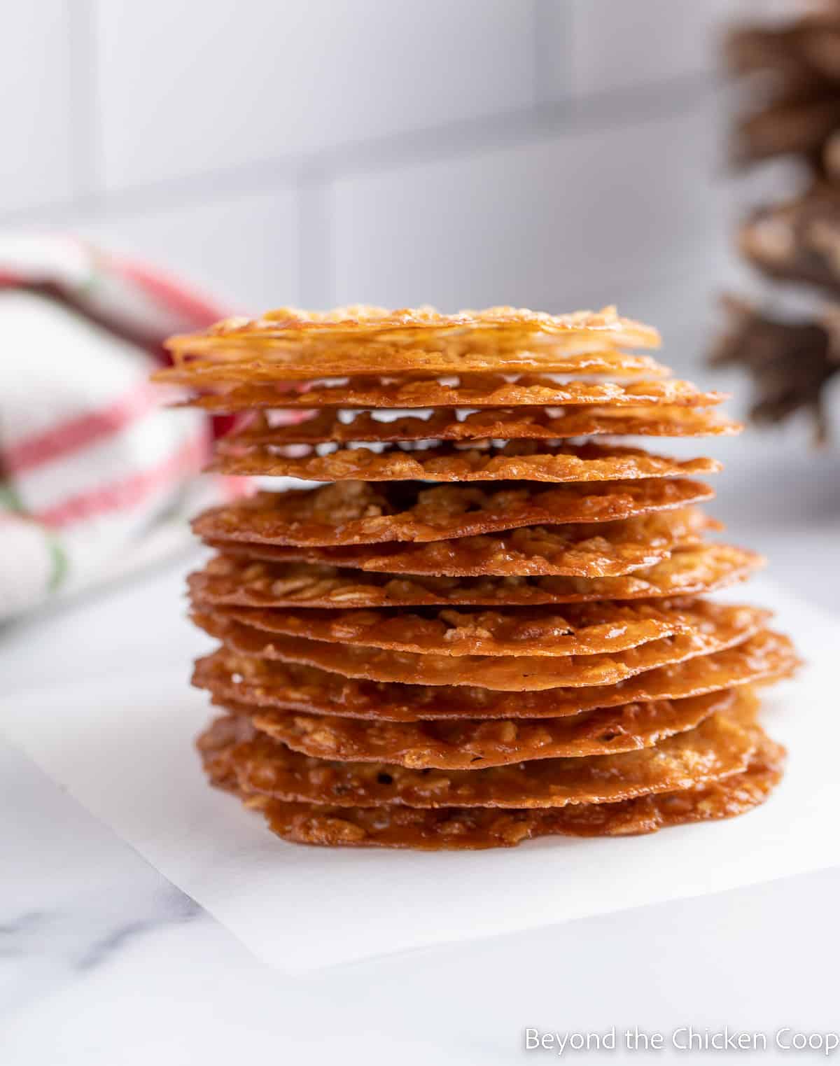 Stacked thin cookies on a small piece of parchment paper.