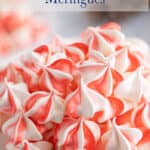 Red and white meringue cookies on a plate.