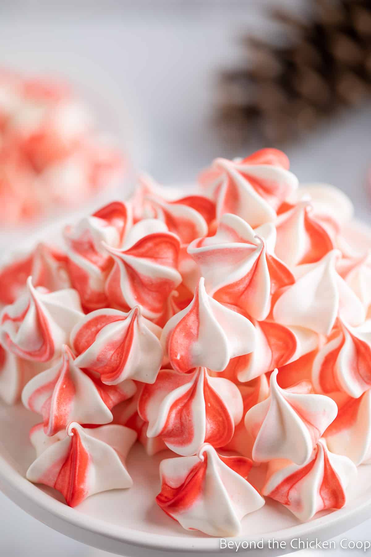 Red and white striped cookies on a white plate. 
