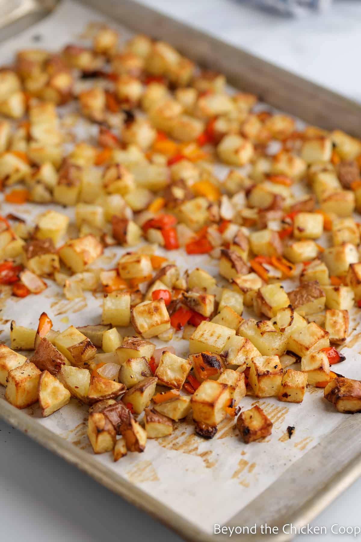 Cooked breakfast potatoes on a sheet pan. 