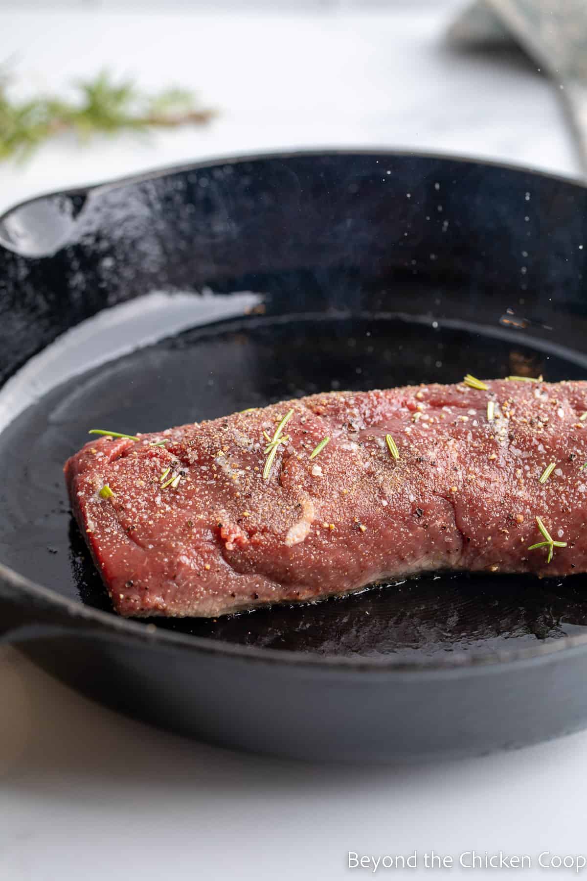 Cooking a venison backstrap in a cast iron skillet. 