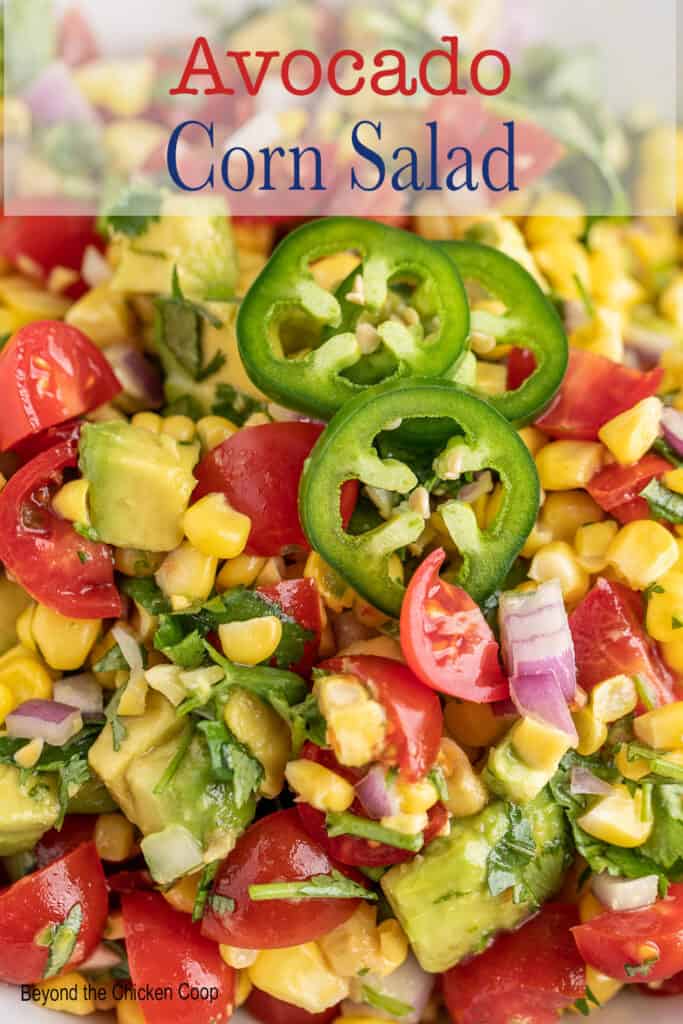 Chunked avocado, tomatoes and corn in a bowl.