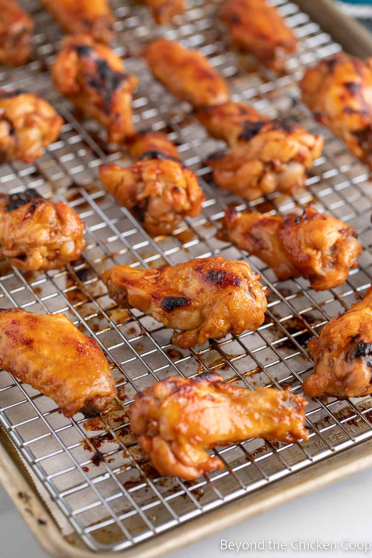 Baked chicken wings on a baking rack. 