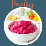 Beet hummus in a white bowl.