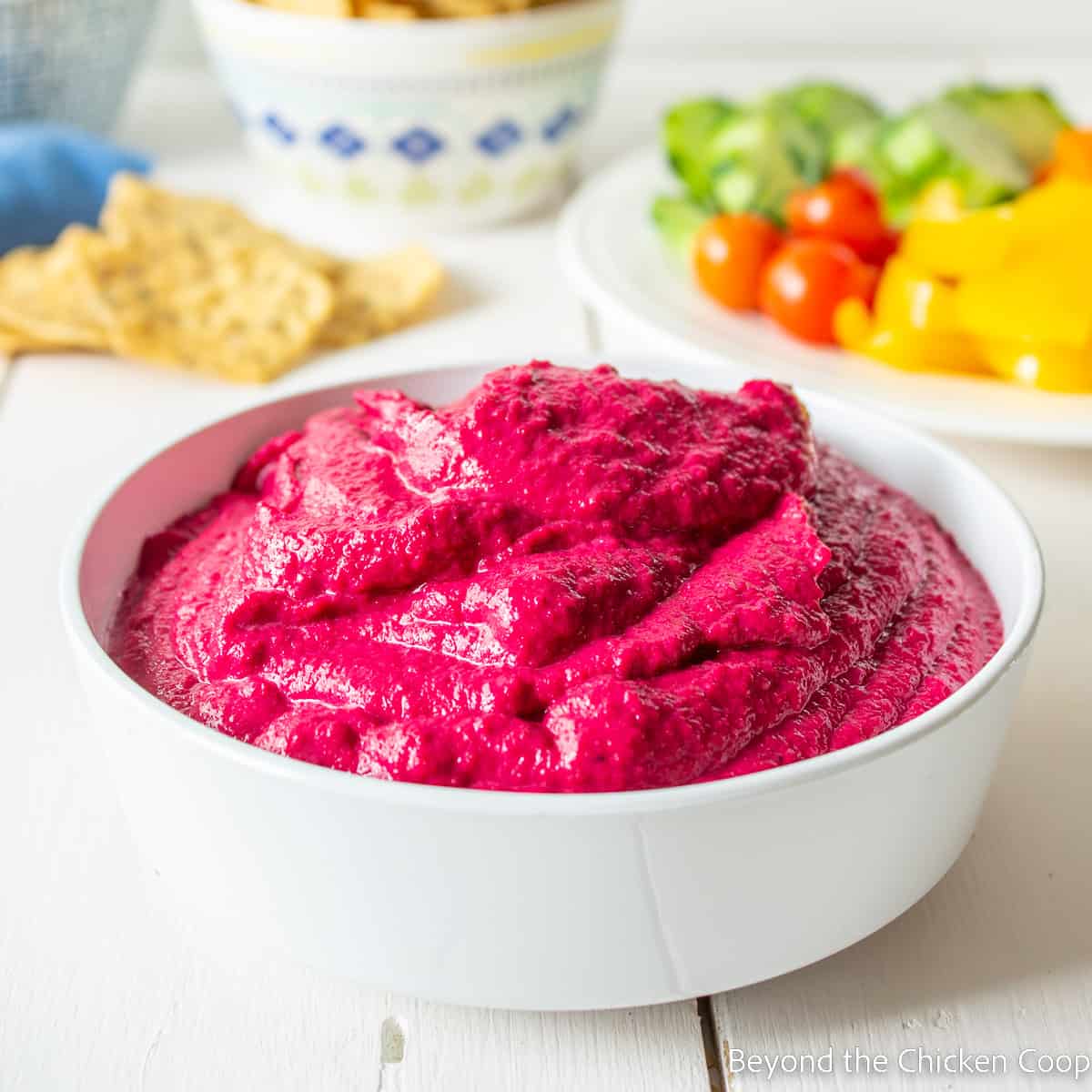 A bowl filled with bright pink hummus.