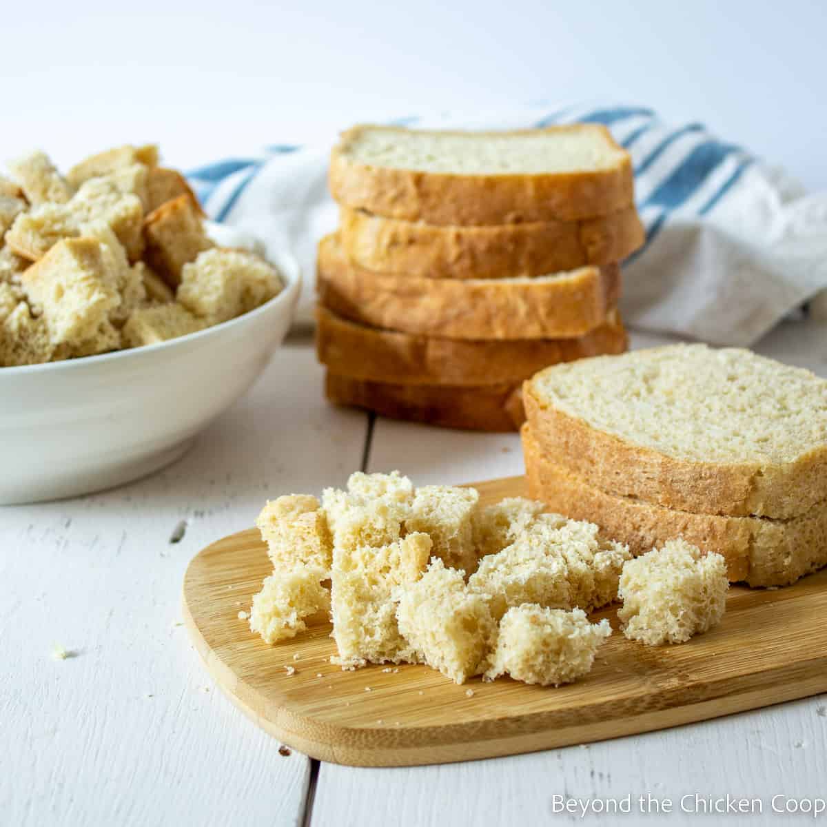 Cubed bread on a cutting board. 