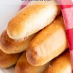 Breadsticks wrapped in a red and white napkin.