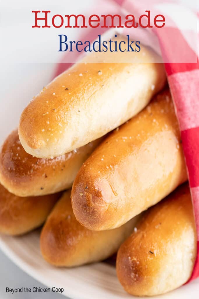 Breadsticks wrapped in a red and white napkin.