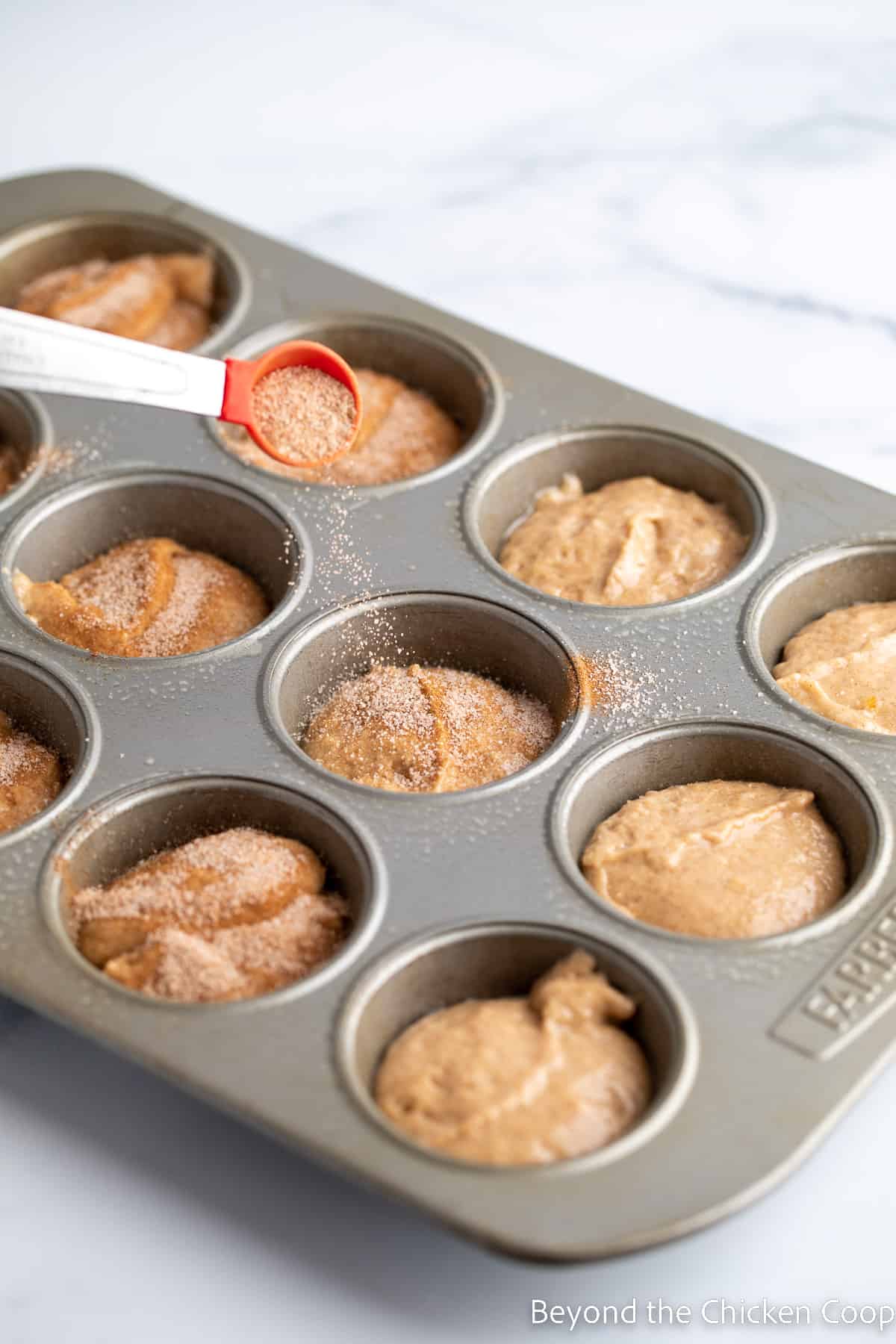 Sprinkling cinnamon sugar over the top of batter. 