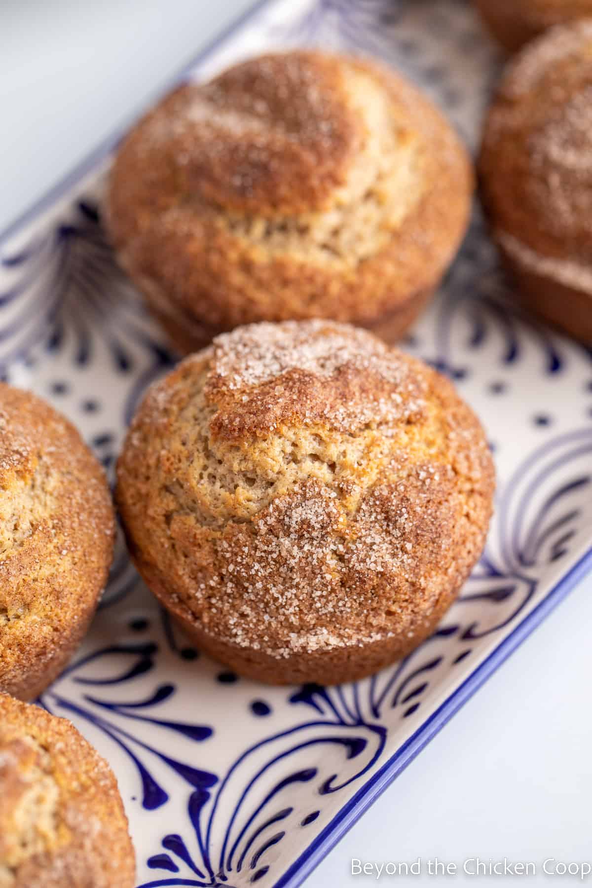 Muffins on a blue and white platter. 