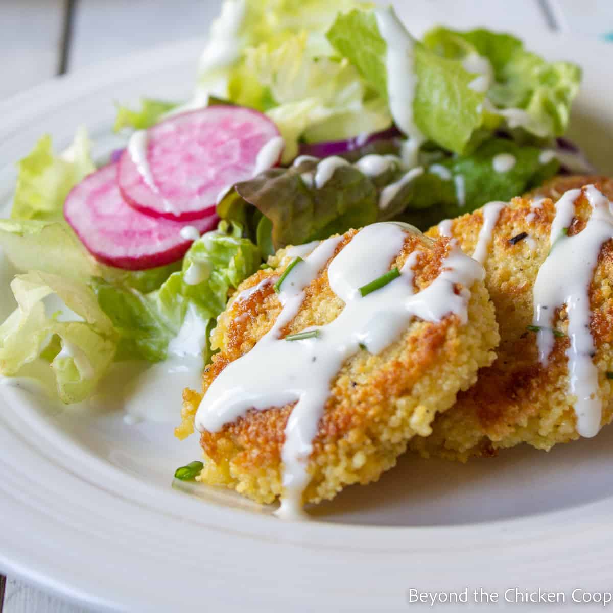 A salad with couscous patties. 