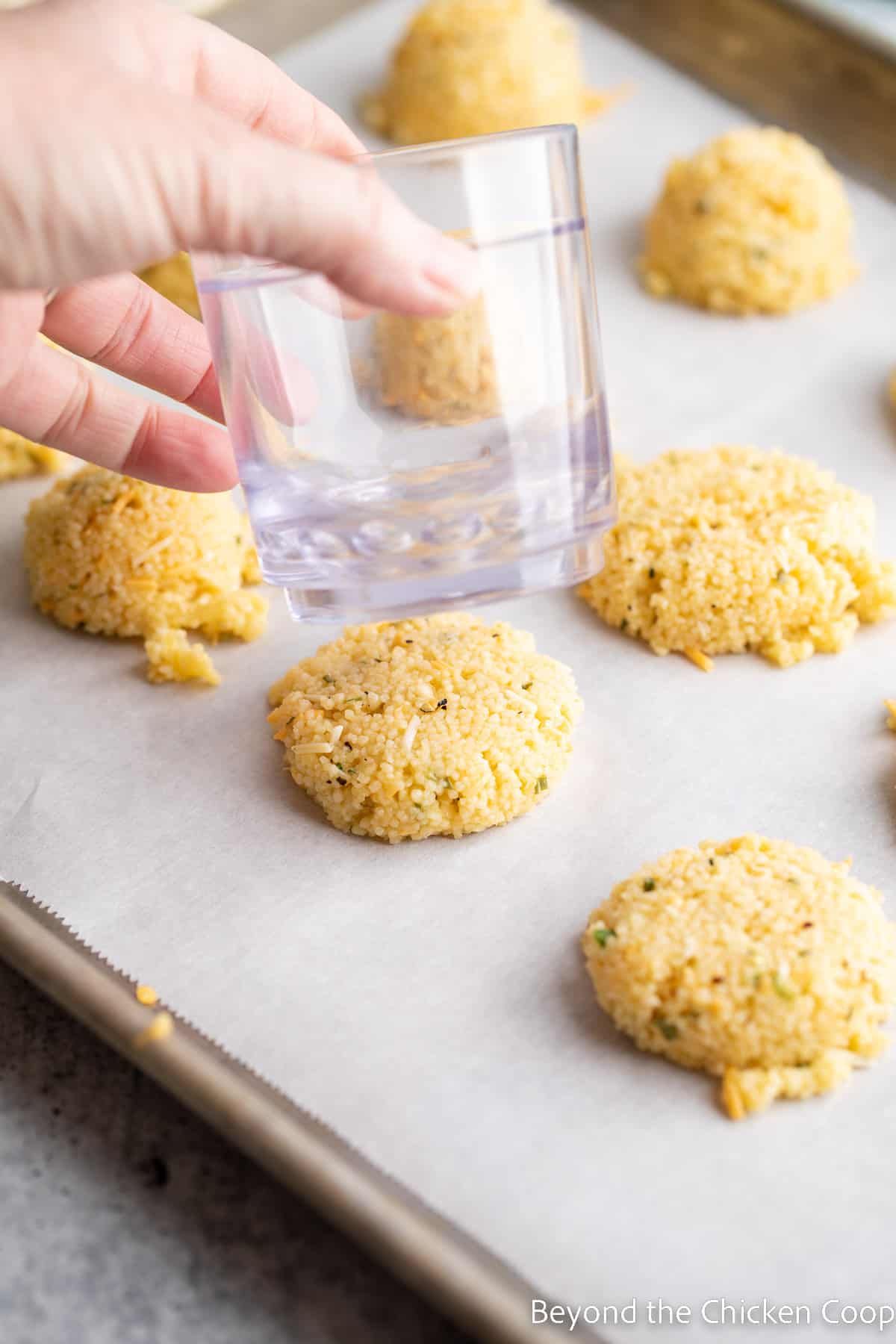 Pressing the couscous patties flat. 