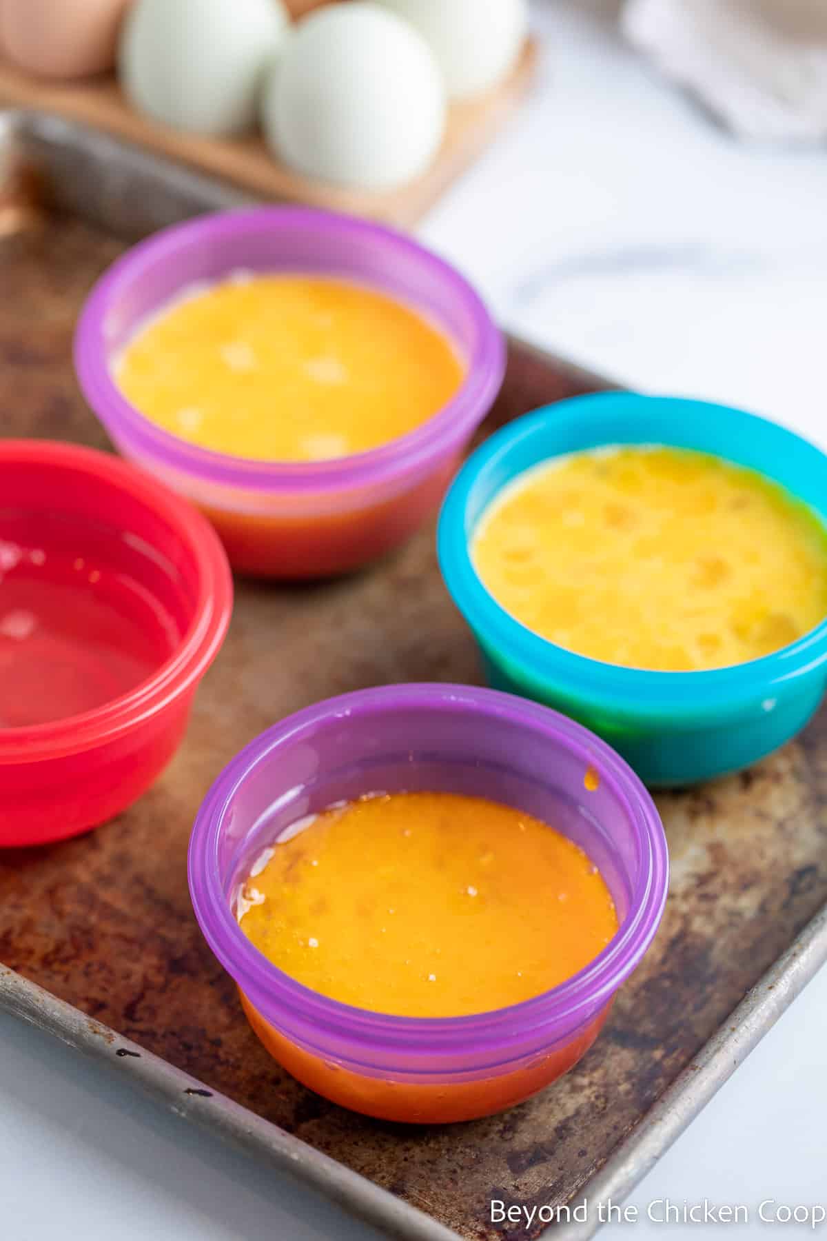 Small containers filled with raw eggs. 