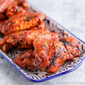 A blue and white platter filled with bbq wings.