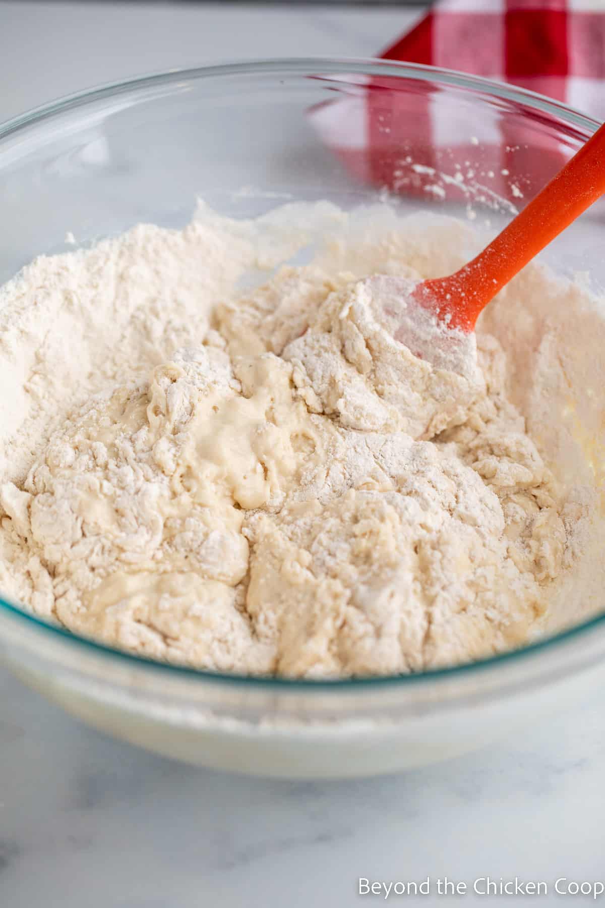 Mixing bread dough with a spatula.