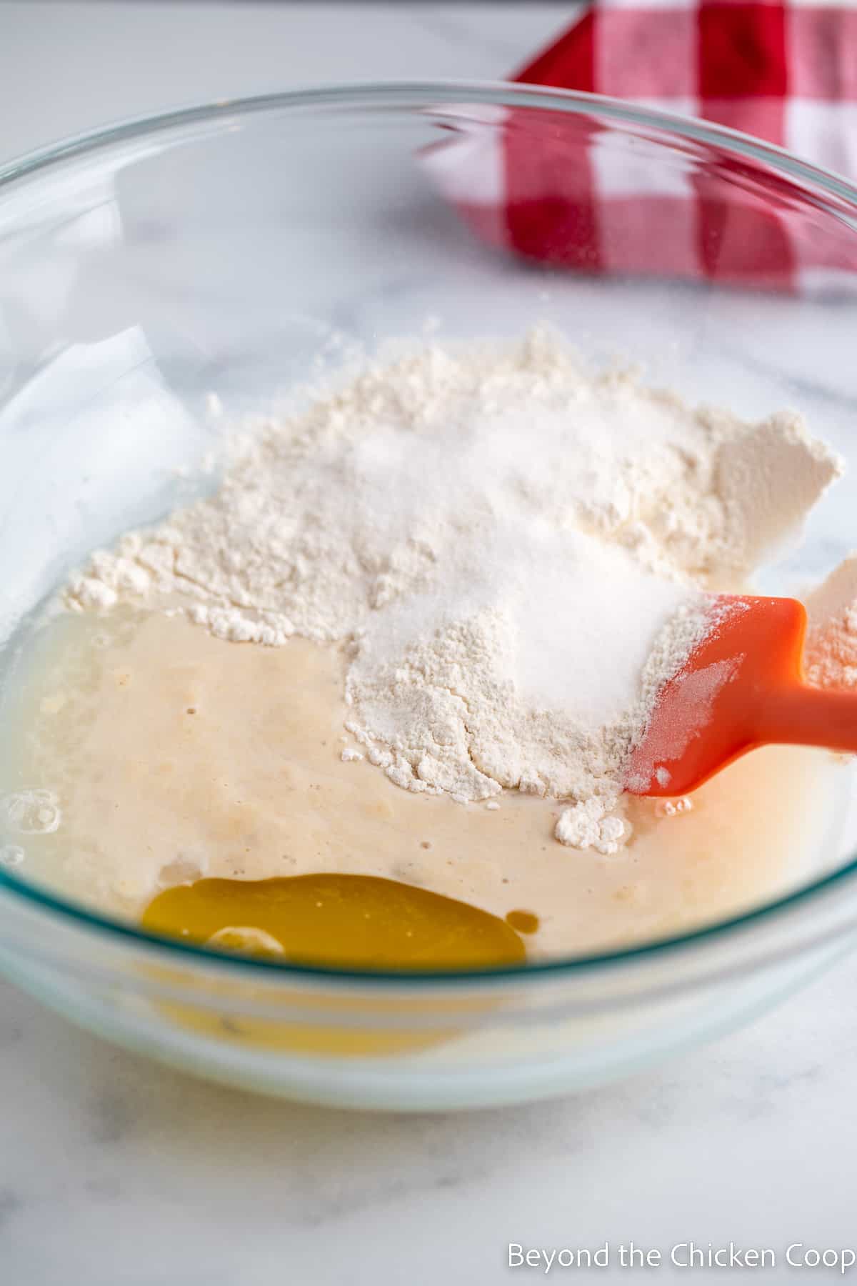 Stirring flour and oil into bread dough. 