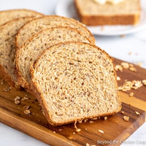 Sliced bread on a wooden cutting board.