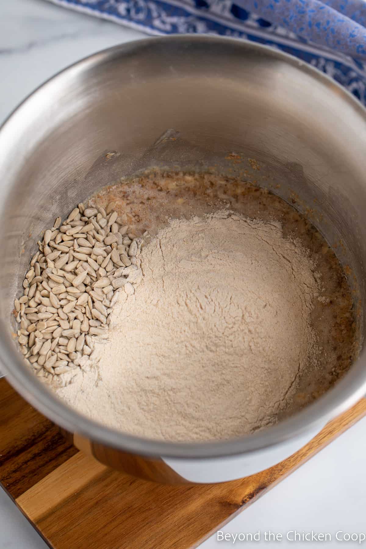 Flour and sunflower seeds in a mixing bowl. 