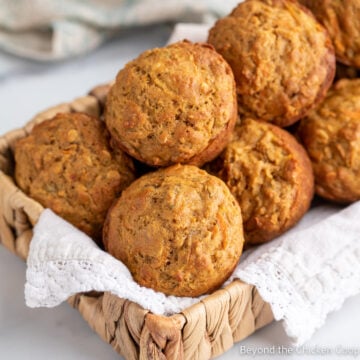 A small basket filled with muffins.