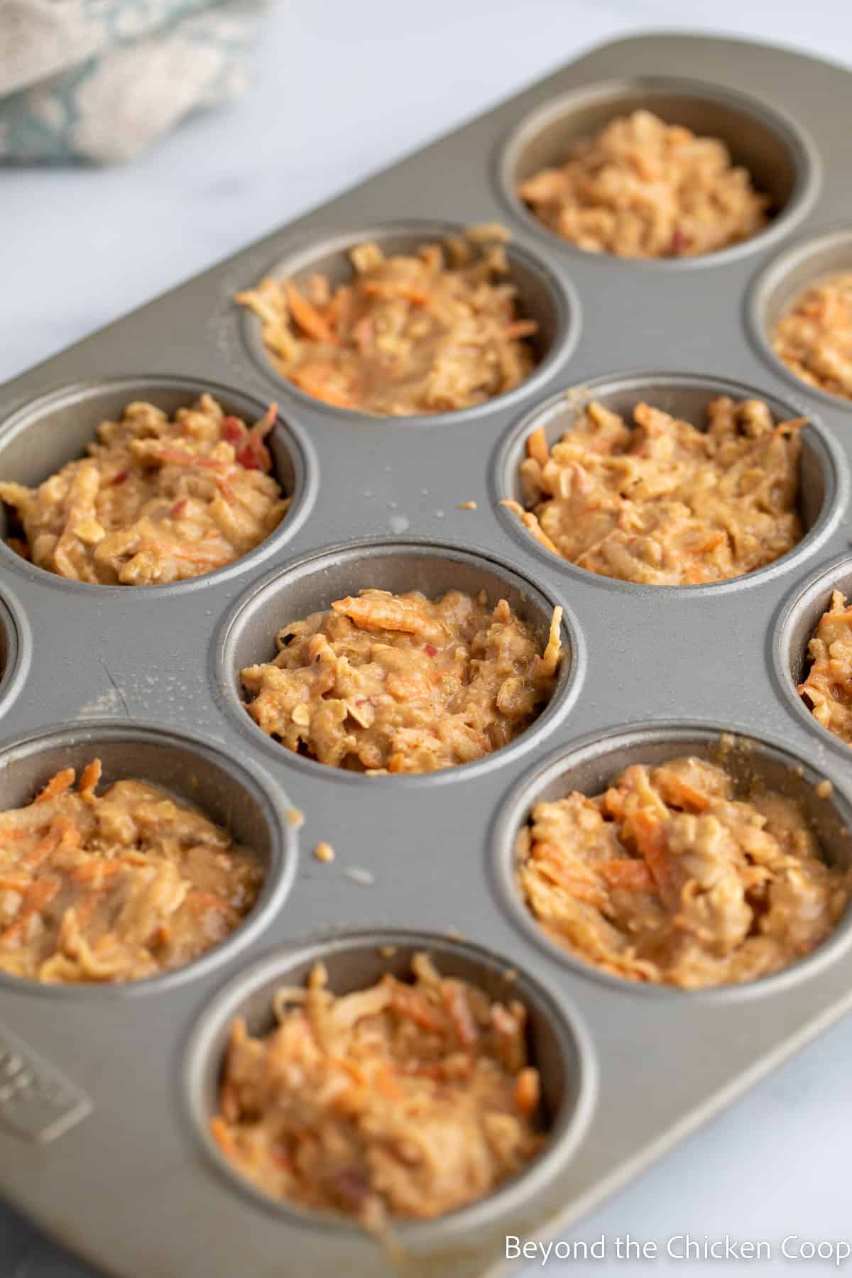 A muffin tin filled with batter.