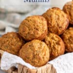 A basket lined with a white napkin and filled with muffins.