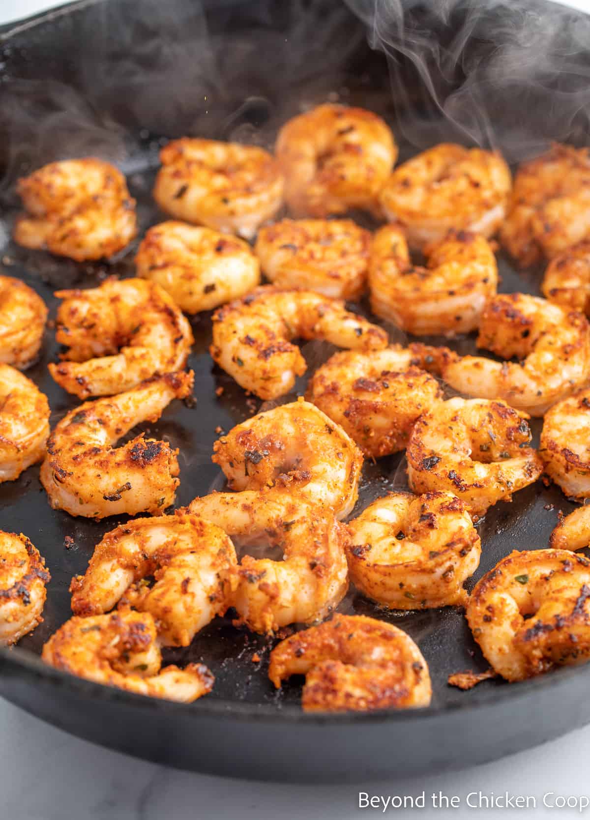 Blackened shrimp in a cast iron skillet.