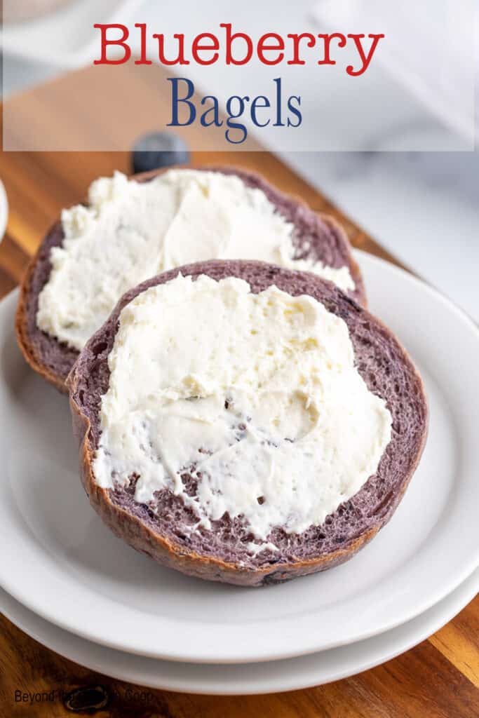 A bagel with cream cheese on a small white plate.