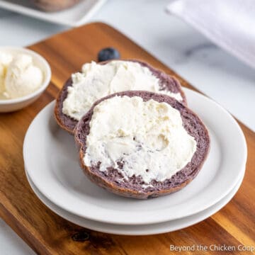 A blueberry bagel topped with cream cheese.