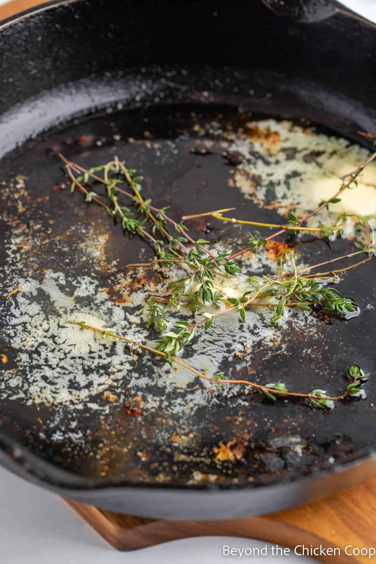Butter and fresh thyme in a cast iron skillet. 