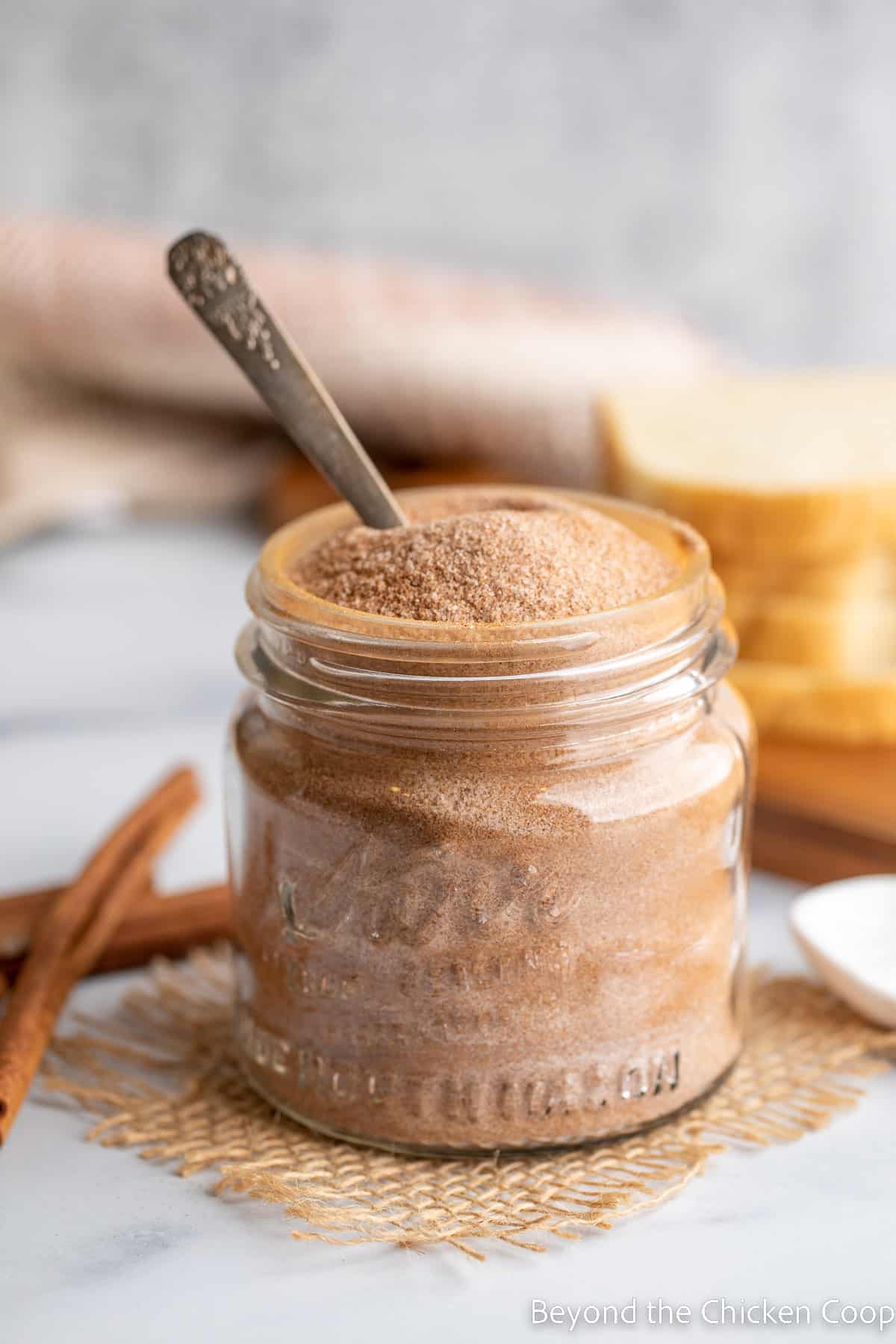 A jar filled with sugar and cinnamon mixed together.